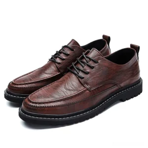 Wine red leather gothic dress shoes for men featuring brogue stitching details and durable non-slip sole, three-quarter angle