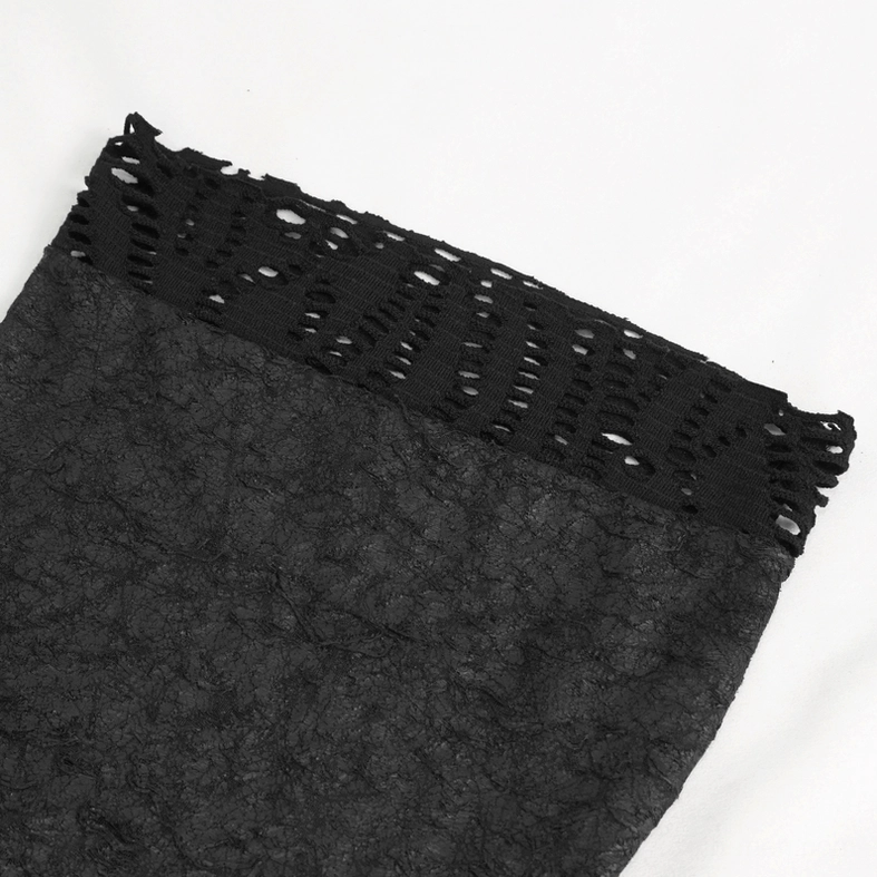 Flat lay close-up of asymmetrical gothic top fabric showing cutout lace edge and crinkled knit texture