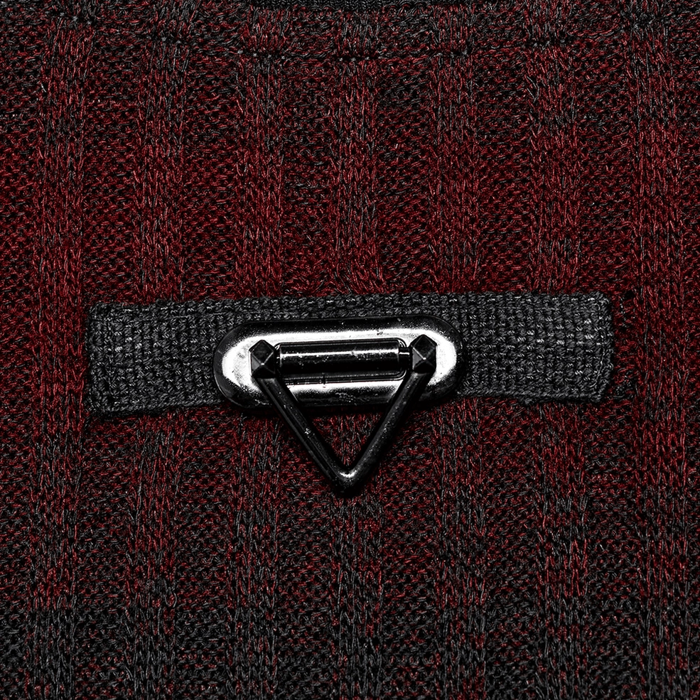 Close-up hardware detail of triangular metal badge on gothic striped knit sweater