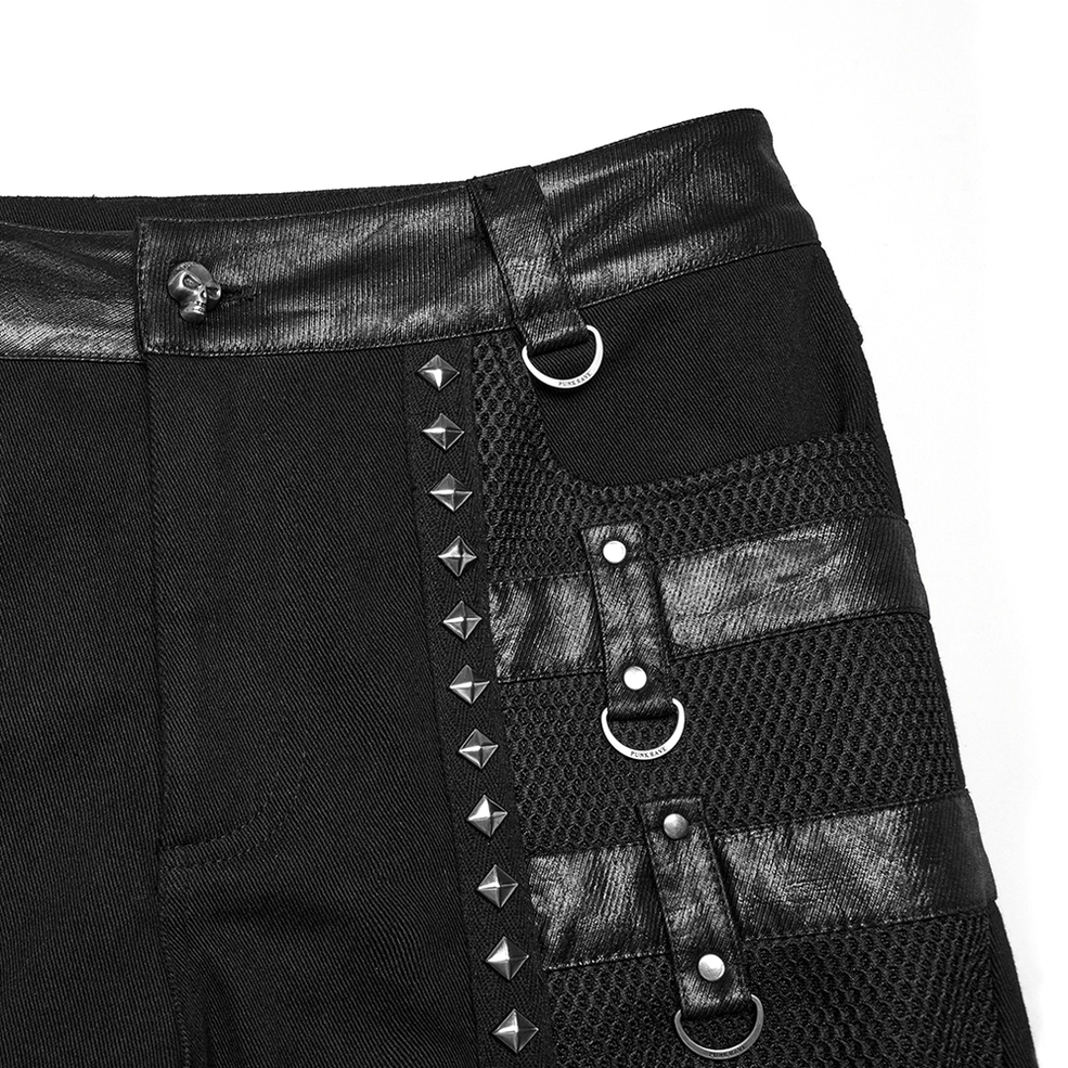Front waist close-up of metal studded goth pants showing pyramid studs, leather straps, D-rings, and mesh integration