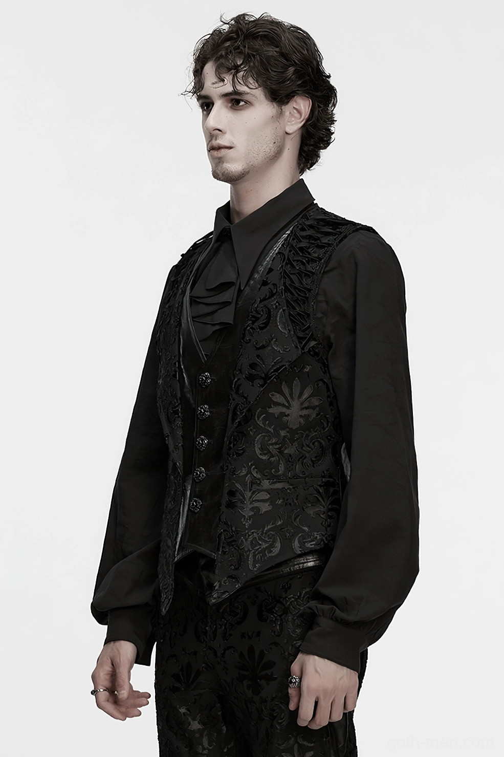 Black gothic embroidered waistcoat worn by male model showing damask pattern and leather accent placement