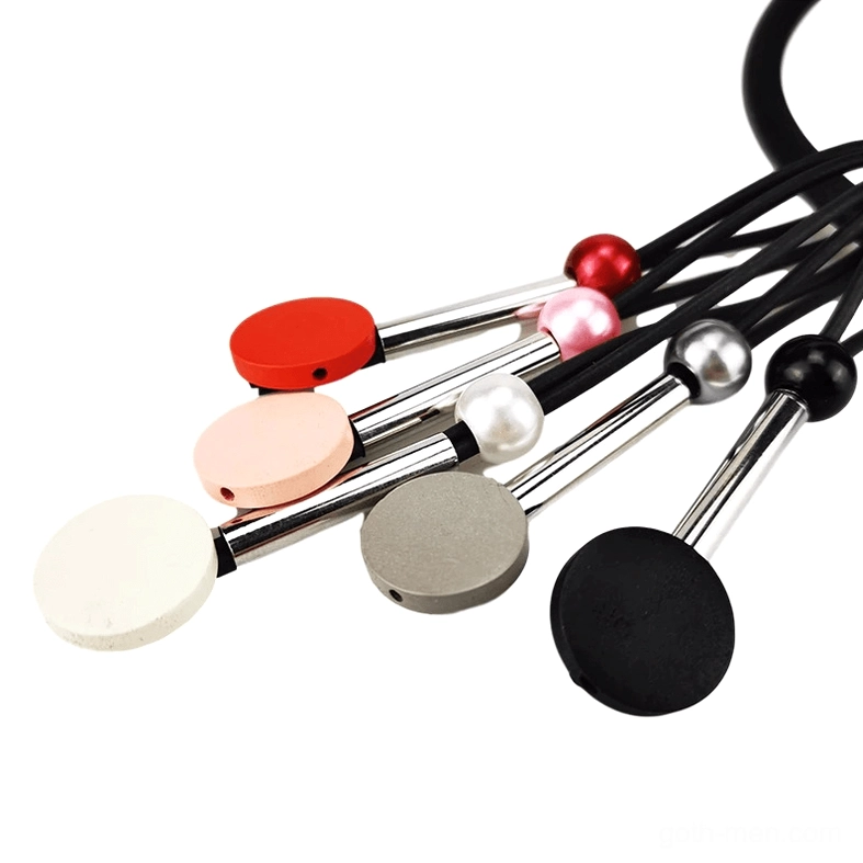 Close-up top-down view of individual matte bead pendants in red, pink, grey, white, and black with metal rods for gothic necklace