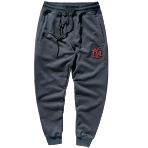 Dark navy blue embroidered jogger sweatpants with red NY logo, flat lay studio shot, gothic alternative style