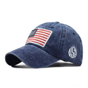 Navy blue washed cotton gothic USA flag baseball cap with embroidered patch, studio product photography left angle