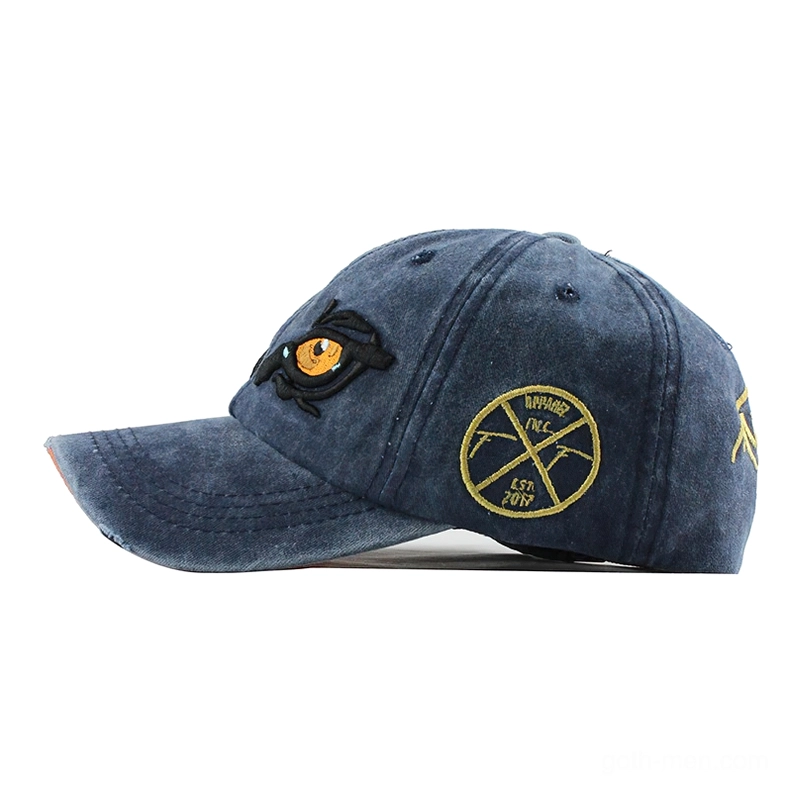 Navy blue gothic eagle eye cap side view, showing golden round logo and embroidery detail