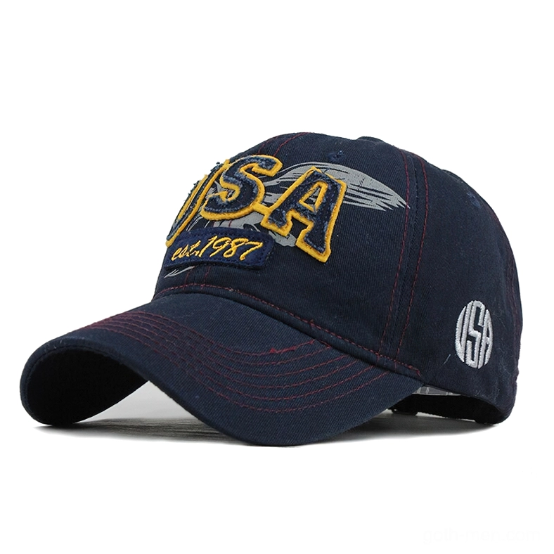 Navy blue vintage baseball cap with yellow USA lettering and est.1987 patch, three-quarter front view