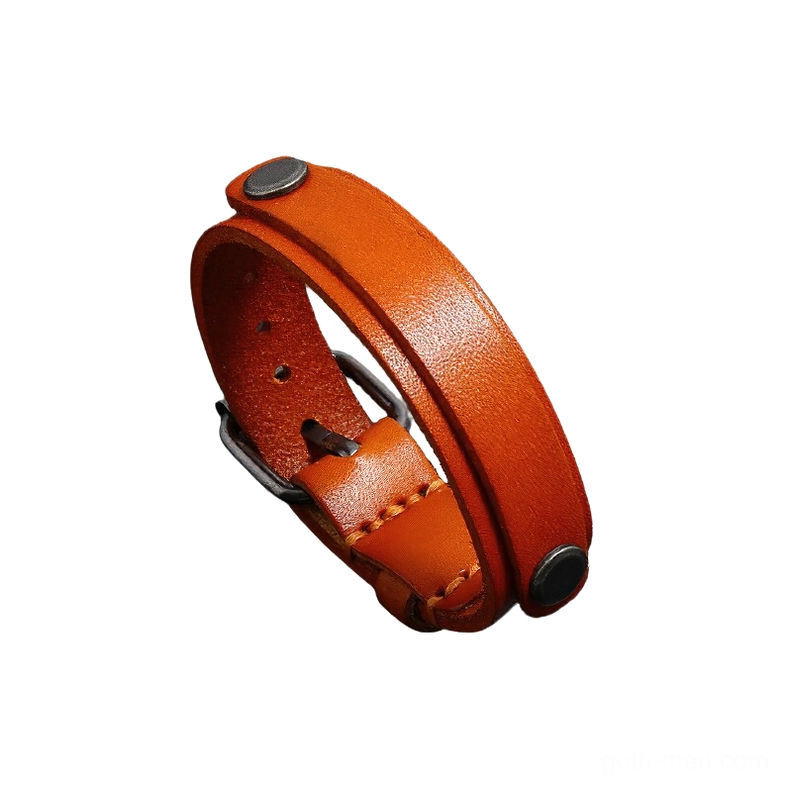 Burnt orange genuine leather punk cuff bracelet with adjustable buckle and antique silver rivets on white background