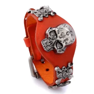 Warm orange-red genuine leather gothic skull bracelet featuring large silver skull decoration, close-up oblique view