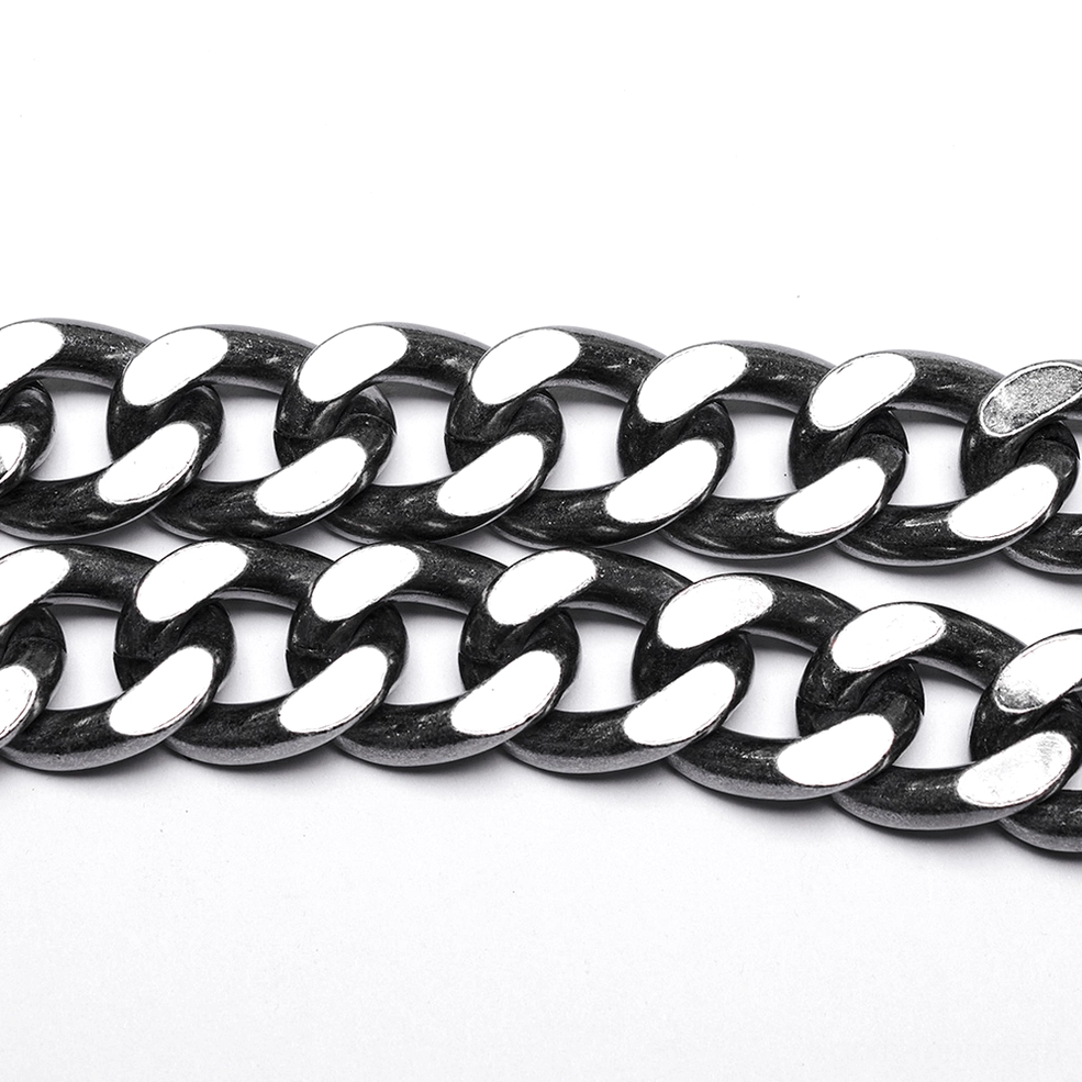 Flat lay close-up of heavy-duty oversized curb chain links with polished antique silver finish for chain harness