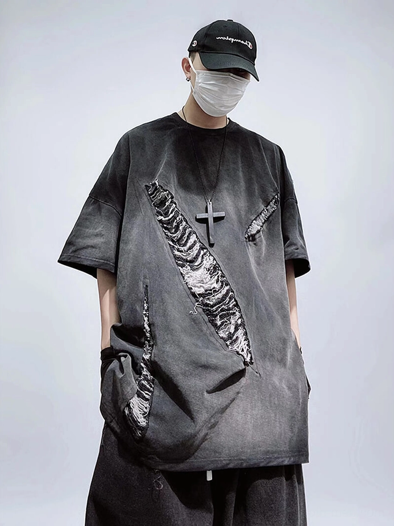 Oversized grunge ripped T-shirt charcoal gray side pocket detail, front view on male model wearing accessories