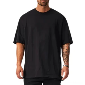 Black oversized gothic crew neck t-shirt with dropped shoulders on tattooed male model, front view