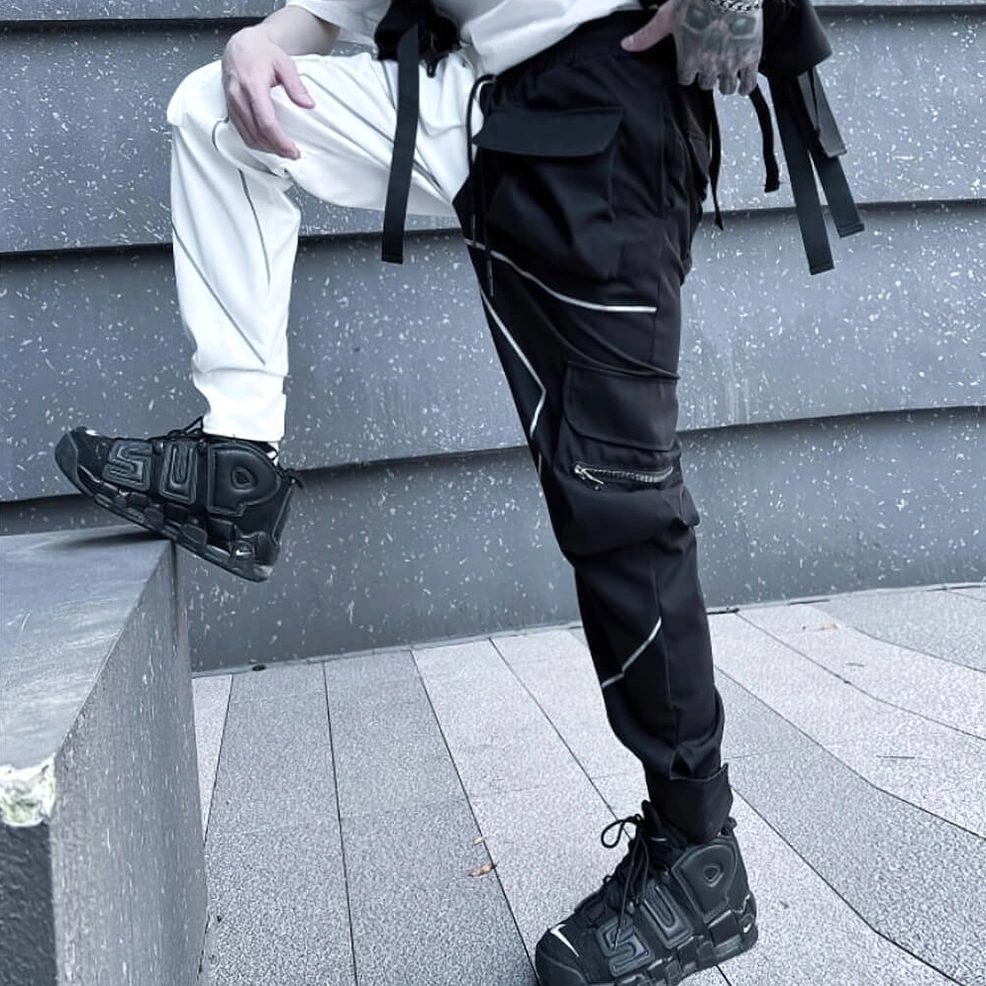 Black and white patchwork gothic cargo pants full length display with tactical webbing and reflective trim