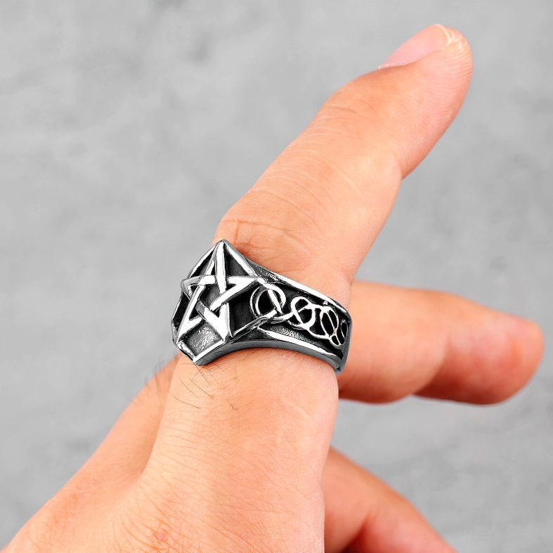 Pentagram ring worn on human finger, side profile showing vintage silver-black finish and gothic aesthetic
