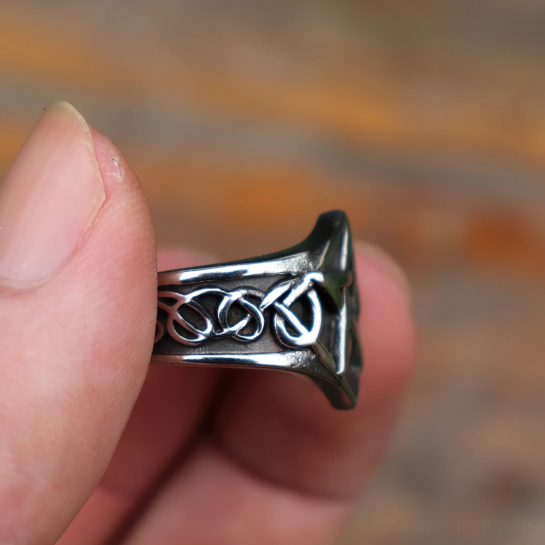 Pentagram ring held between fingers showing side band view with engraved Celtic knot details