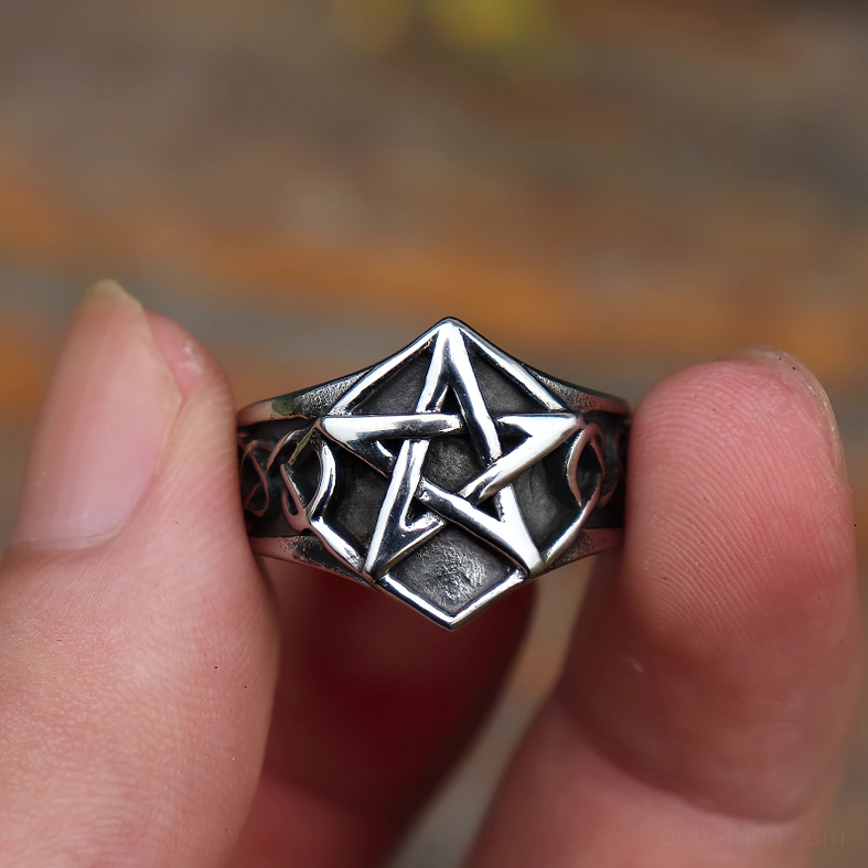 Stainless steel pentagram ring front view held in hand displaying prominent five-pointed star and Celtic engravings