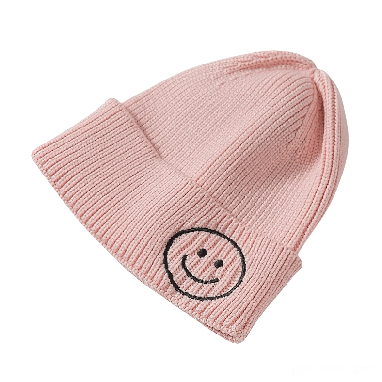 Pink knit beanie with dark accent smiley embroidery, softgoth aesthetic