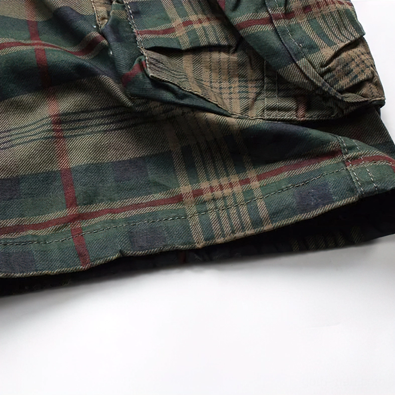 Close-up of tartan plaid side seam and stitching detail on gothic cargo shorts