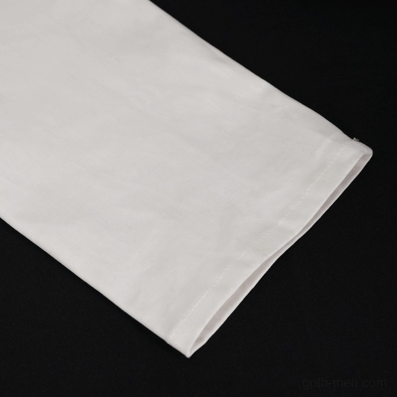 Macro detail photograph of white gothic punk shirt cuff section showing hemmed edge and cuff buckle hardware