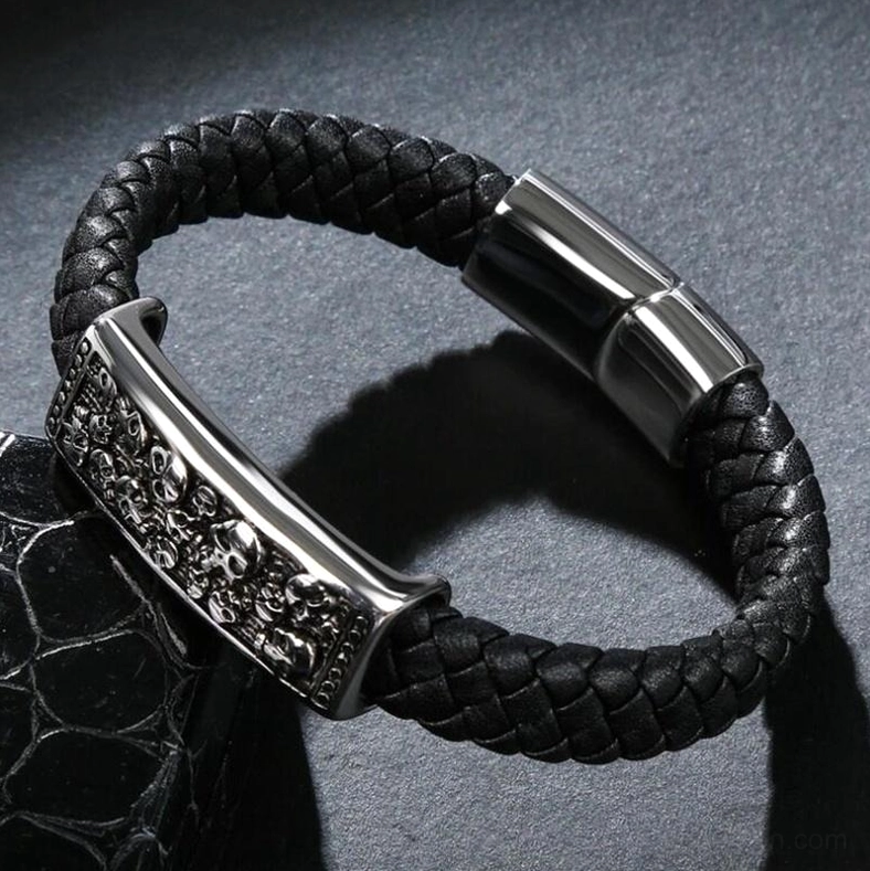 Aged finish punk leather skull bracelet with gun black metal clasp displayed on textured background, gothic style detail