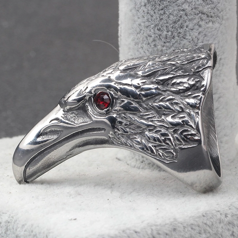 Raven head gothic ring displayed on jewelry stand showing side profile and feather carving