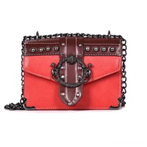 Red gothic square shoulder bag with metal chain strap and rivet details, front view flat lay