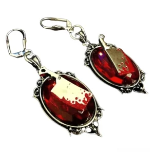 Red bloody meat cleaver gothic earrings with gold-toned cleaver and ornate silver frame, angled flat view on white background