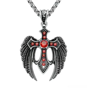 Red gemstone winged cross pendant necklace with silver curb chain gothic jewelry flat lay
