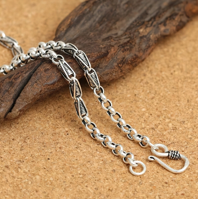 Retro-style 925 sterling silver twisted link chain necklace with antiqued finish on wooden slab, showcasing gothic aesthetic detail