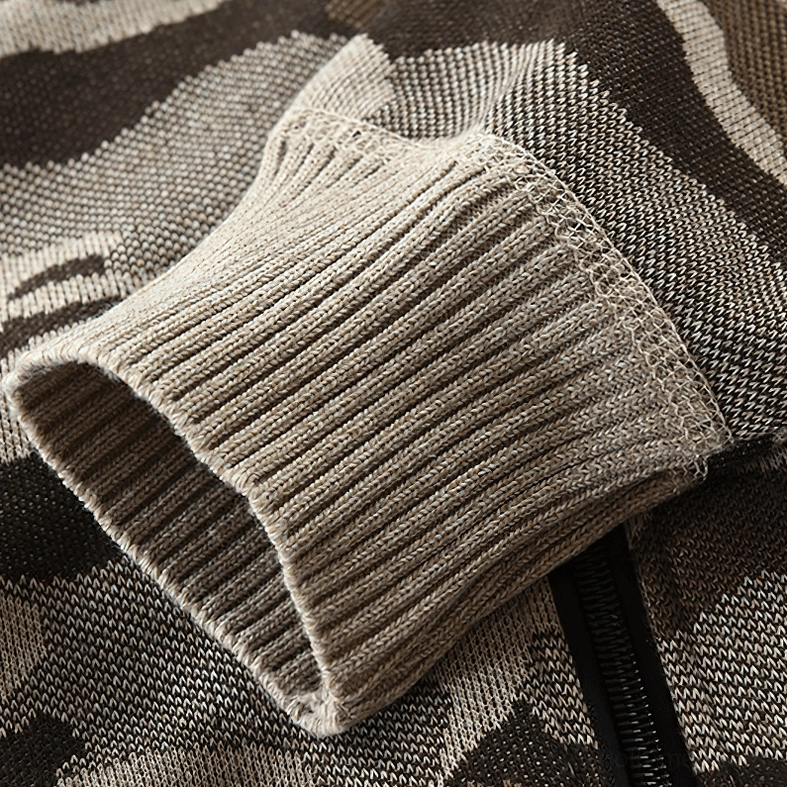 Close-up of ribbed knit cuff with zipper trim and camouflage knit fabric on hooded cardigan sleeve