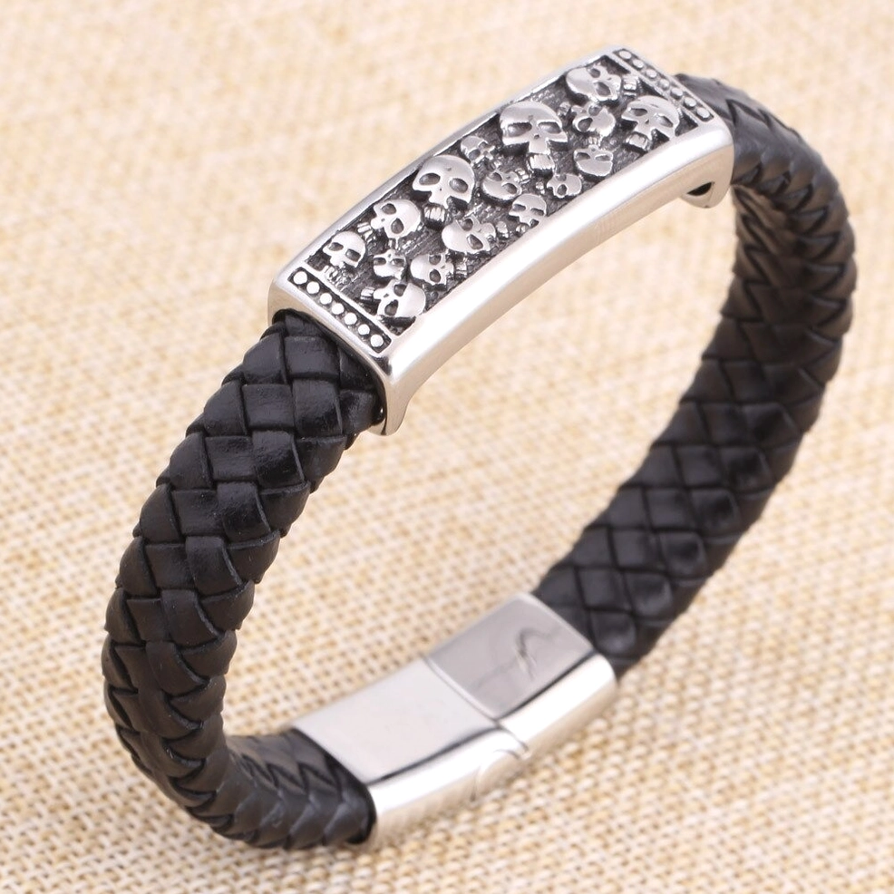 Rock style men's leather skull bracelet featuring stainless steel hardware, right side view with fabric background