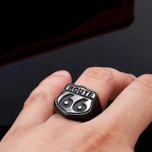 Route 66 gothic biker ring worn on male hand in close-up, embossed shield design visible