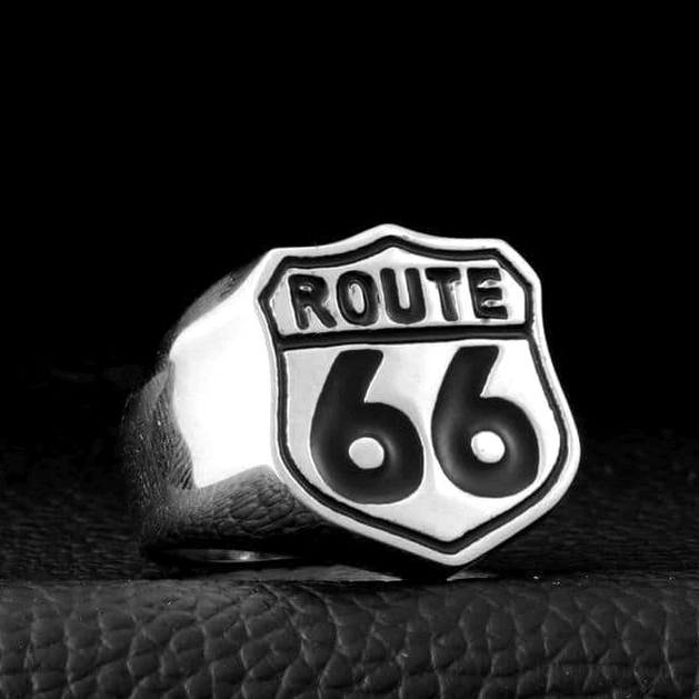 Polished stainless steel Route 66 shield ring with black enamel detail, front-side view on leather