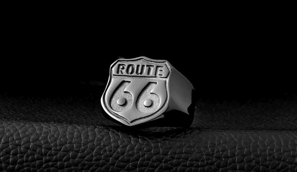 Route 66 highway sign ring in stainless steel with vintage patina, side angle on leather texture