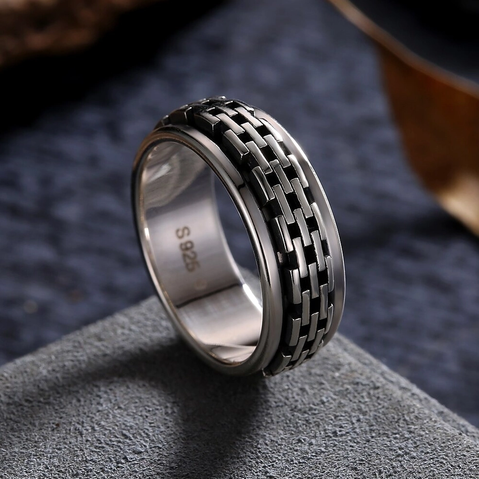 Sterling silver 925 stamped chain link biker ring, 3/4 side angle on dark fabric background showing vintage authenticity