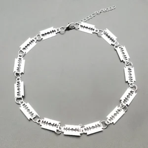 Overhead flat lay shot of silver blade choker necklace displaying full length chain with lobster clasp closure and adjustable extension link