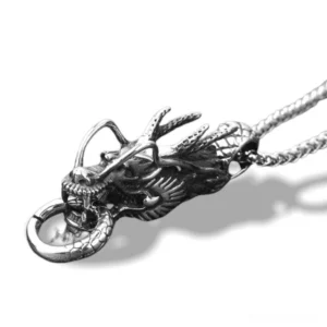Silver antique dragon head pendant necklace side view, gothic stainless steel jewelry with detailed carved texture