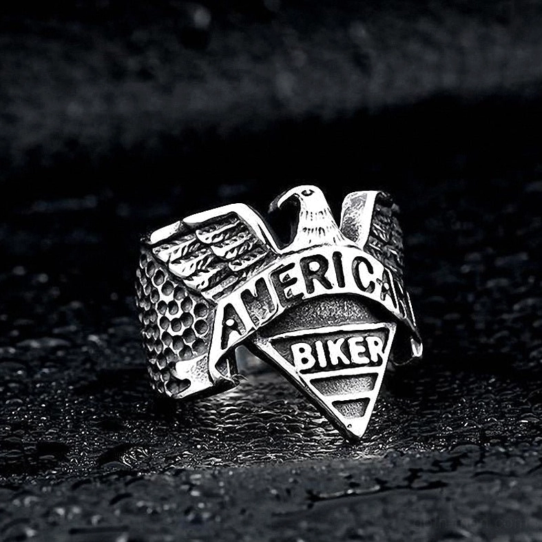 Silver gothic eagle ring oblique view showcasing detailed wing feather texture and engraved text