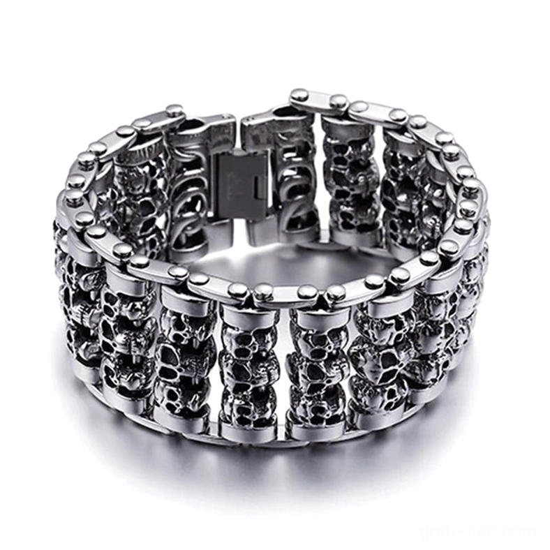 Silver gothic skull chain bracelet for men with stacked skull heads and fold clasp, flat lay top view