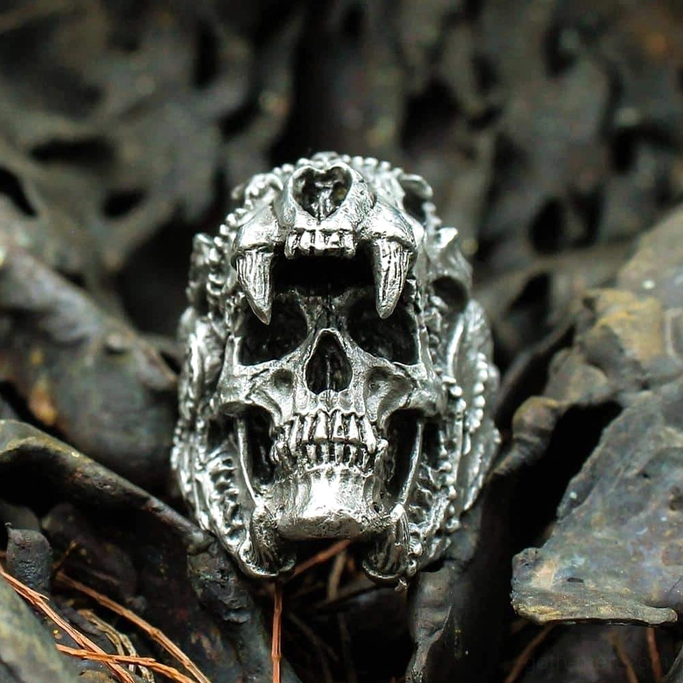 Silver-toned stainless steel gothic skull ring with complex carved details and warrior aesthetics, frontal close-up