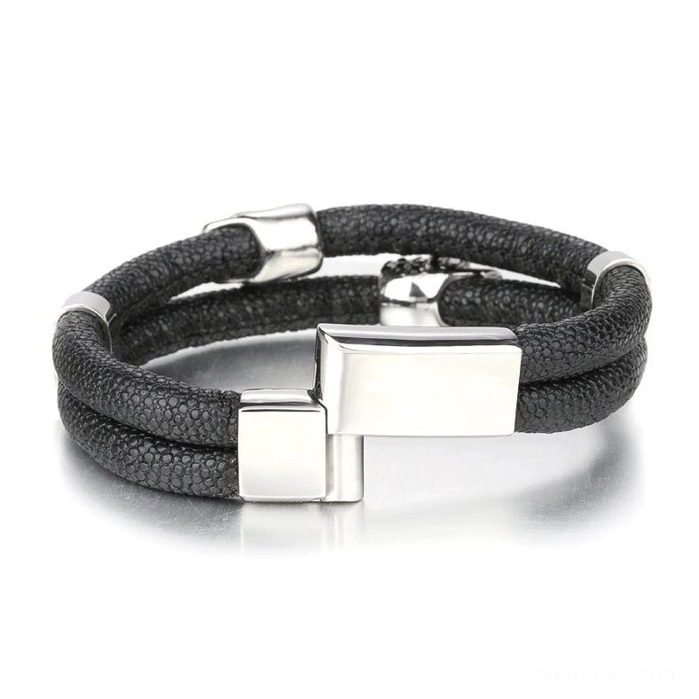 Silver-finish magnetic clasp and hardware detail on men's gothic leather skull bracelet, studio lighting