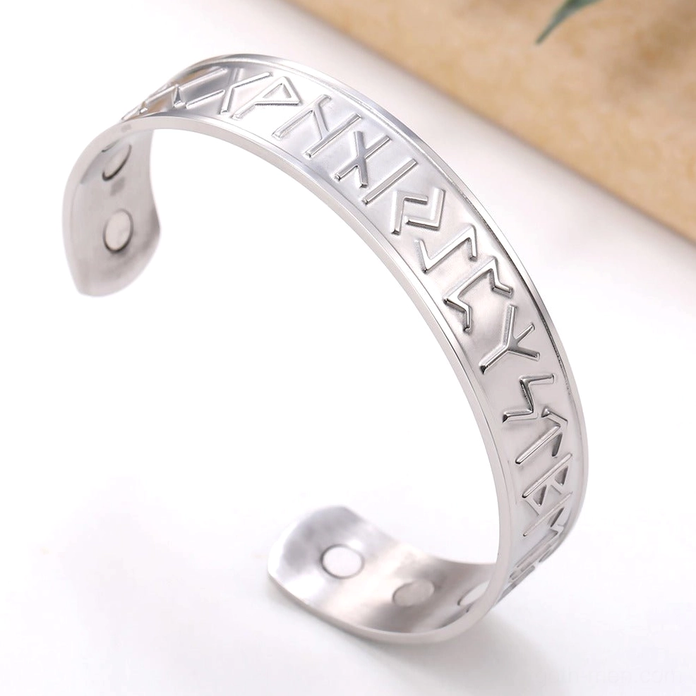 Silver stainless steel Nordic rune magnetic cuff bracelet with smooth rune engravings, wooden surface styling