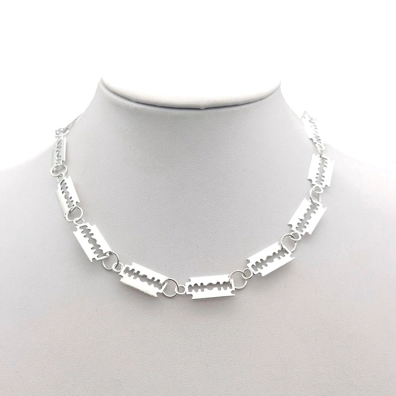 Silver razor blade gothic choker necklace worn on mannequin head, front view showing 14 interlocking blade links with chain design