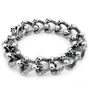 Silver skull curb chain bracelet double-row flat lay overhead view showing intricate twisted links with multiple skull accents and antique distressed finish