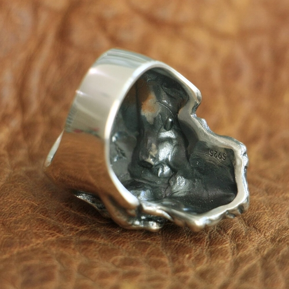 Sterling silver skull ring interior showing S925 hallmark stamp and distressed inner texture