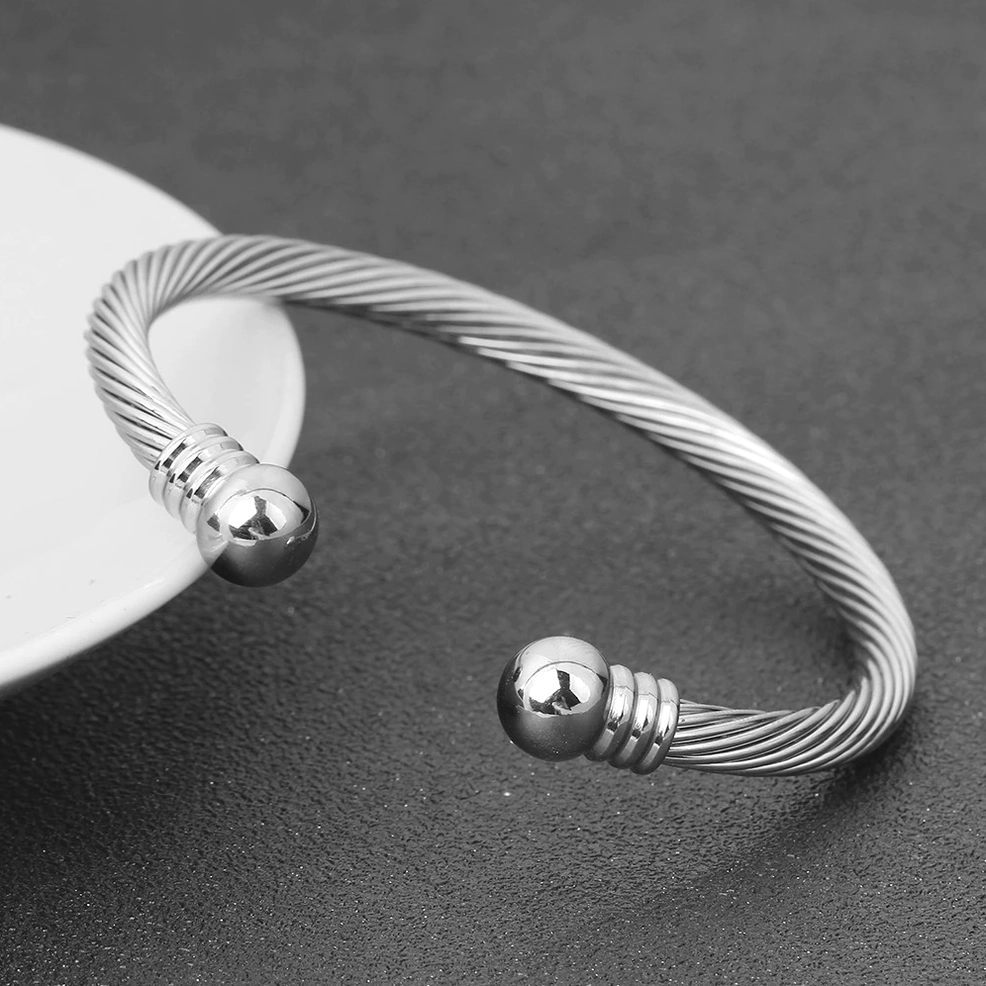 All-silver twisted cable open cuff bracelet with smooth polished spherical ends, gothic minimalist design