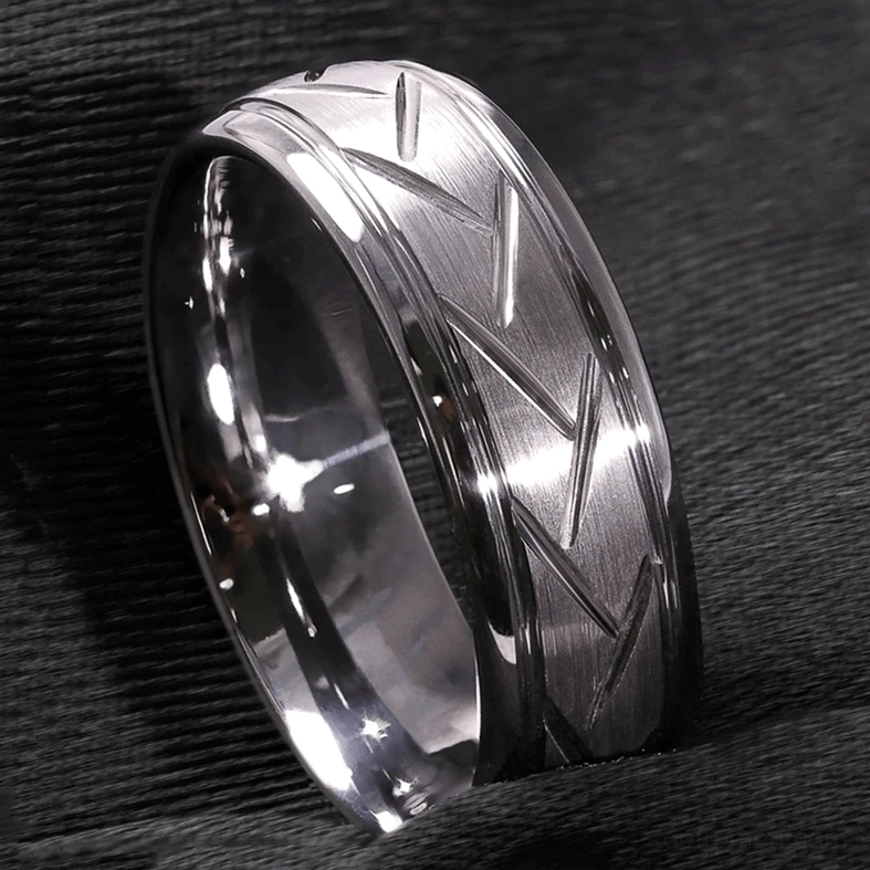 Silver chevron zigzag gothic ring with brushed metallic finish on dark background, geometric pattern detail
