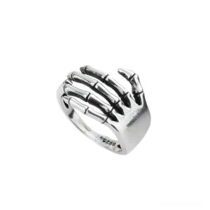 Skeleton hand hug ring in polished silver, gothic jewelry with detailed articulated fingers, studio shot showing full skeletal hand design