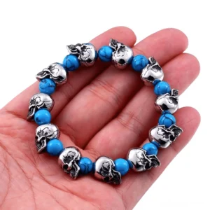 Unisex gothic skull bracelet worn on hand, close-up detail showing vintage silver finish and blue beads