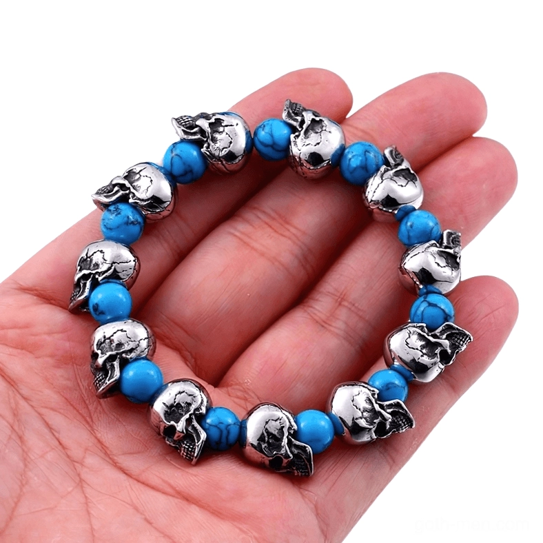 Unisex gothic skull bracelet worn on hand, close-up detail showing vintage silver finish and blue beads