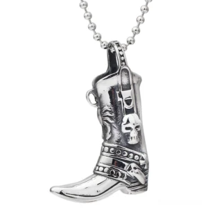 Skull-engraved cowboy boot gothic pendant necklace with ball-beaded chain, front three-quarter view showing intricate skull motifs on stainless steel